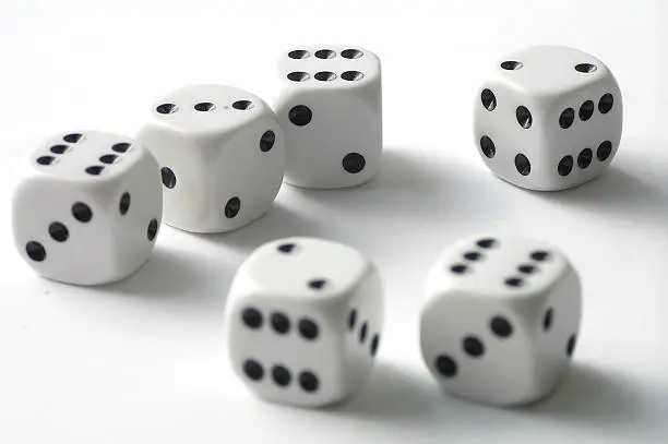 Dice on white table - a close-up