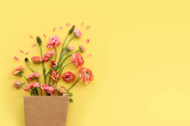 istock Top view image of pink flowers composition over yellow background 1397121428