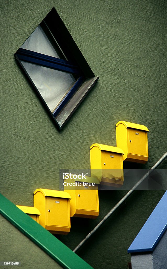 Five Yellow Letter-Boxes Letter-boxes diagonal on the wall. Anticipation Stock Photo