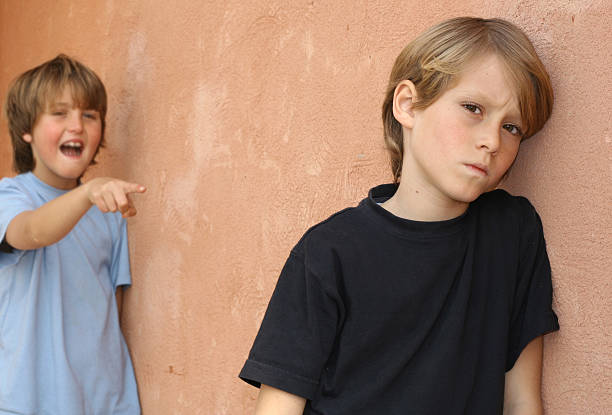 school bully, Young boy bullying another child stock photo