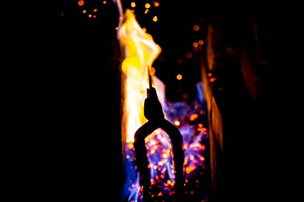 Charcoal burning and forging metal steel for small Japanese samurai katana sword.