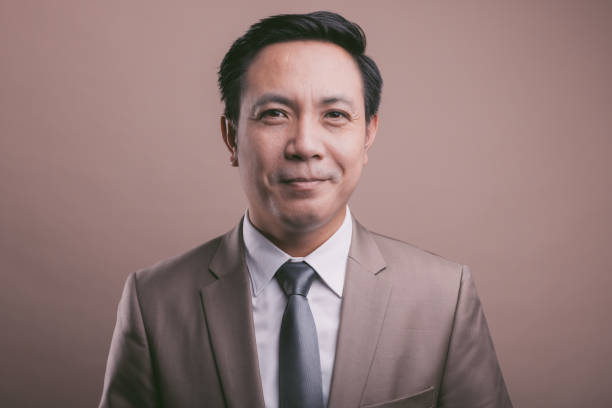 asian businessman portrait, looking at camera. smiling and laughing. - medium shot imagens e fotografias de stock