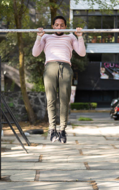 istock Young man doing calisthenics exercises in a park 1397128317