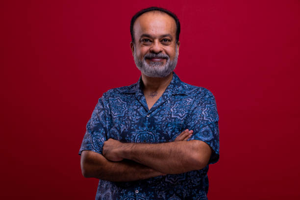 istock Smiling Mature Indian man portrait in red background. 1397128553