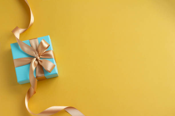 istock Image of a refreshing gift with a plain yellow background and a blue gift Father's Day 1397130116