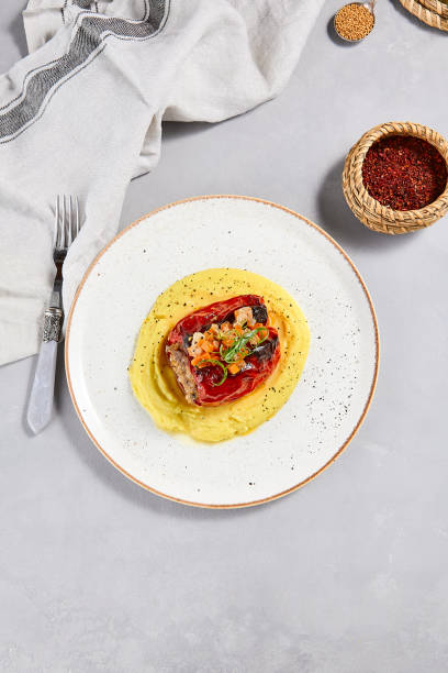 istock Eastern cuisine - stuffed paprika with mashed potatoes. Stuffed pepper with pure on ceramic plate in contemporary style. Modern concept eastern food menu. Aesthetic composition with main course. 1397132487
