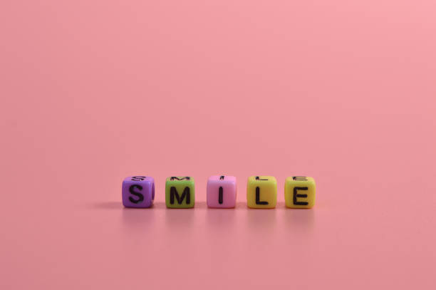 istock Colorful alphabet letters with text SMILE isolated on pink background 1397133480