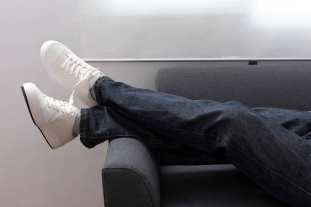 istock White sneaker and blue jean with sofa. 1397138225