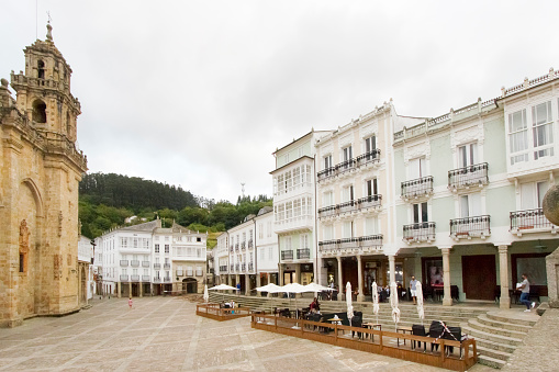Mondoñedo, Lugo, Spain- August 10, 2022: Mondoñedo cathedral  town square with traditional residential buildings, sidewalk cafes. A Mariña, Lugo province, Galicia, Spain.