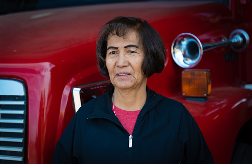 Indigenous Navajo Fire station worker on her 60s portrait in front of a fire engine
