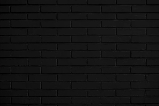 Horizontal vector illustration of a dark black colored textured effect bricks pattern backgrounds. Apt for use as wallpaper, design templates. Simple elegant design, matte finish backdrop with copy space for text. There is no text and no people.