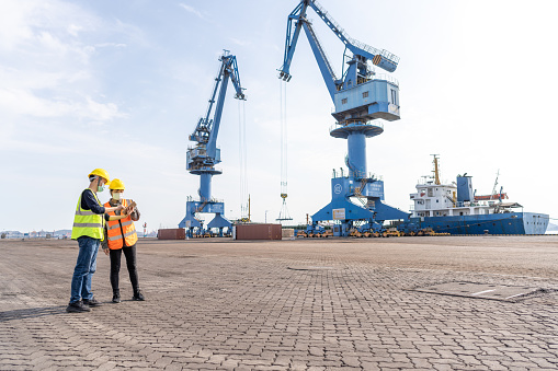 Men and women dock managers talk at the port