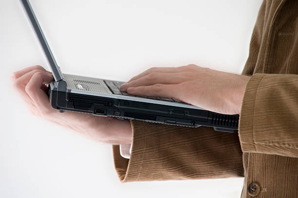 man holding laptop stock photo