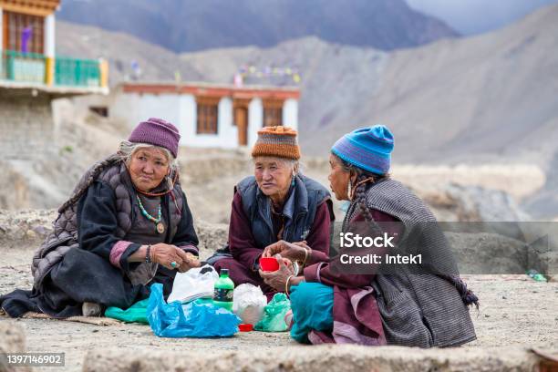 Old Buddhist People Drink Tea And Eat Food On The Street Next To The Monastery Lamayuru In Ladakh North India Stock Photo - Download Image Now