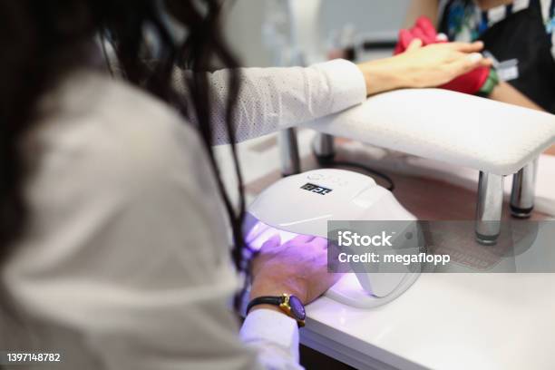 Lady Drying Gel In Ultraviolet Lamp Stock Photo - Download Image Now - Manicure, Gel Pack, Fingernail