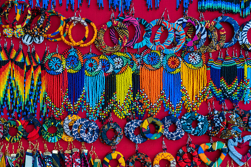 Tribal masai colorful earrings for sale for tourists at the beach market, close up. Island of Zanzibar, Tanzania, East Africa