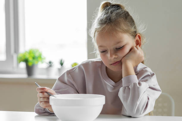 Girl doesn't want to eat stock photo