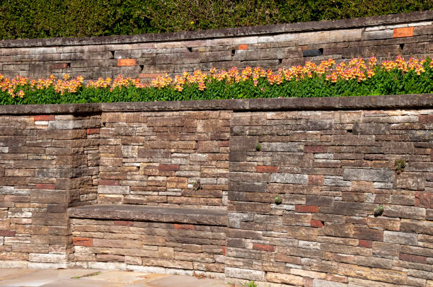 istock Retaining wall with bench topped with flowering snapdragon's in garden 1397152075