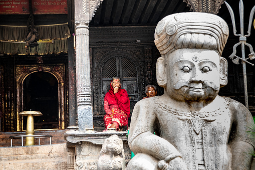 Bhaktapur, Nepal - oct 28, 2019:  pilgrims in front of the entrance to the Dattatreya temple, Bhaktapur, Kathmandu Valley, Nepal