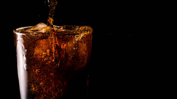 istock Close-up iced cola isolated in the black background 1397154105