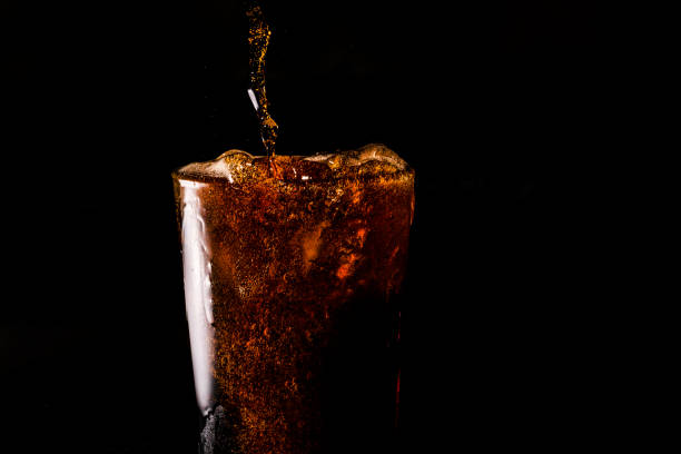 istock Close-up iced cola isolated in the black background 1397154107
