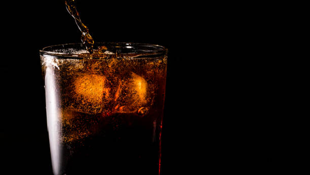 istock Close-up iced cola isolated in the black background 1397154110