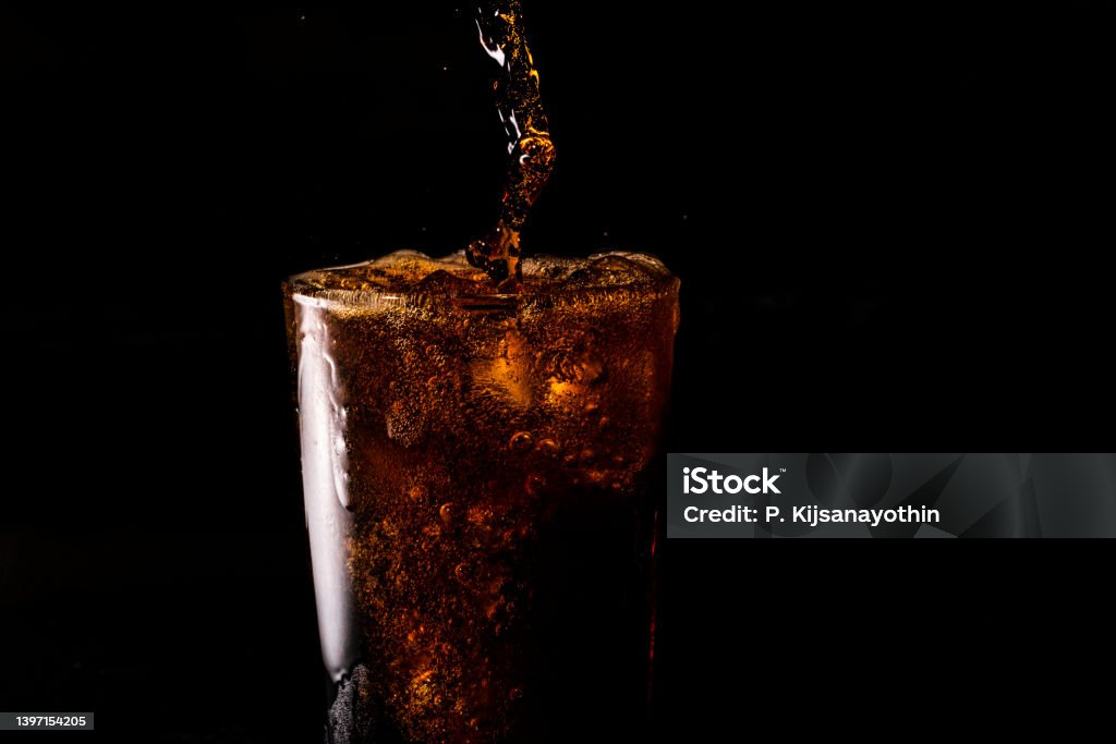 Close-up iced cola isolated in the black background Cola Stock Photo