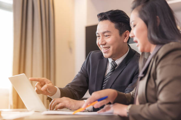 istock Happy employees discussing potential business Two knowledgeable business people working together with laptops while talking about 1397154267