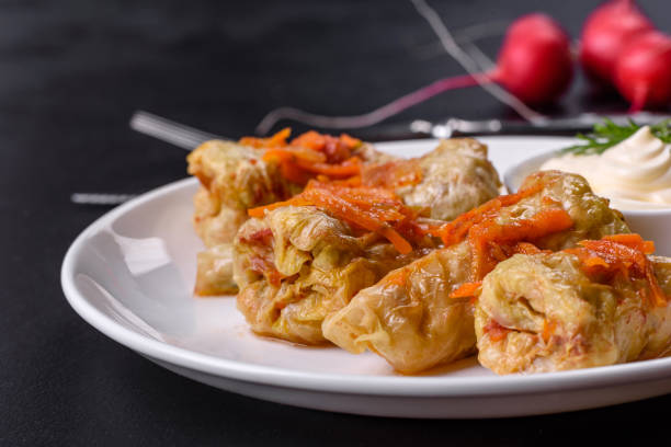 istock Cabbage rolls stuffed with ground beef and rice served on a white plate 1397156681
