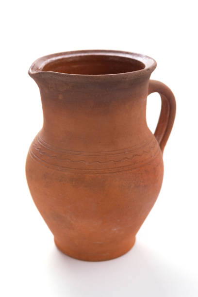 istock Old clay jug isolated at white background 1397158698