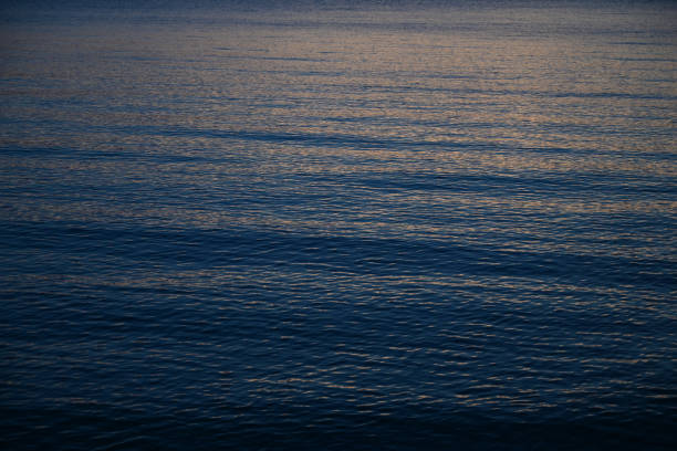 istock dark blue sea background, moody sky 1397164368