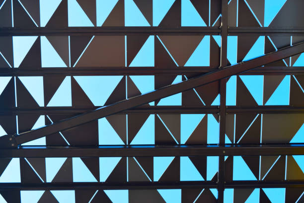 Graphic pattern of black triangles and lines against clear blue sky