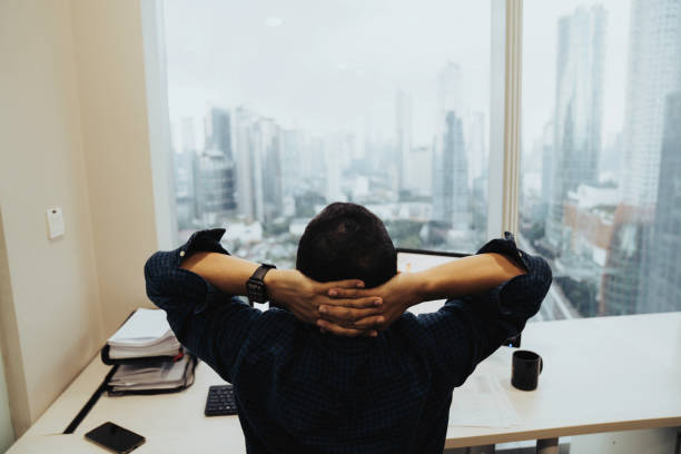 istock asian Architects Working On Blueprint and looking out on stunning Jakarta skyline 1397166017