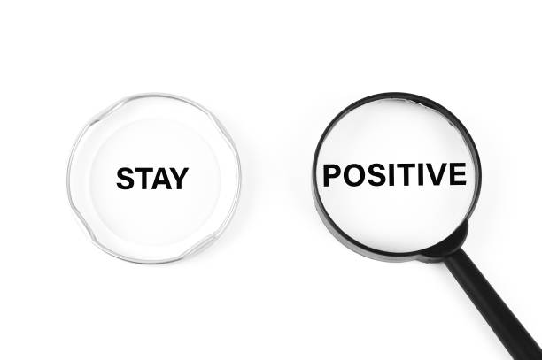 istock Phrase STAY POSITIVE written on bottle cover and magnifying glass 1397166277