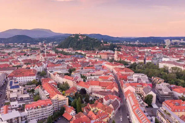 Graz Cityscape in Austria. Graz is the capital city of the southern Austrian province of Styria. At its heart is Hauptplatz, the medieval old town’s main square. Beautiful Sunset Light. Drone.