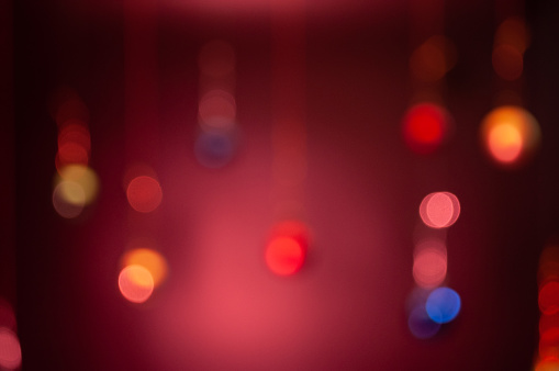 Abstract background with blurred New Year toys, Christmas lights and bokeh .