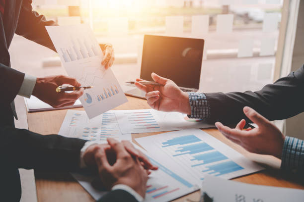 istock Teamwork with price chart analyzes business people on the table at the conference room. 1397171840