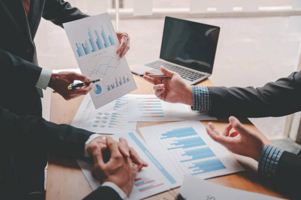 istock Teamwork with price chart analyzes business people on the table at the conference room. 1397171842