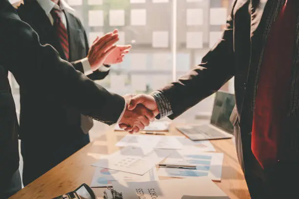 Photo of business partner handshake concept Colleagues shaking hands Successful deal after a great meeting. Blurred background.