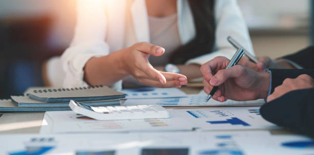 istock Group of business people working on graph chart, talking, planning analyze investment and marketing on tablet in office. 1397177302