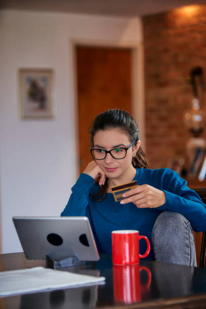 istock Hispanic young woman using digital tablet at home for online shopping with copy space 1397180647