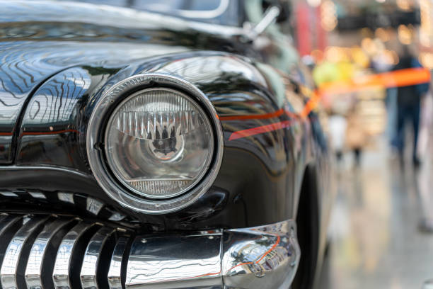 istock Black and glossy retro car, close-up. headlight view 1397180781