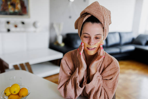 istock A beautiful woman pressing a sheet mask onto her face 1397180852