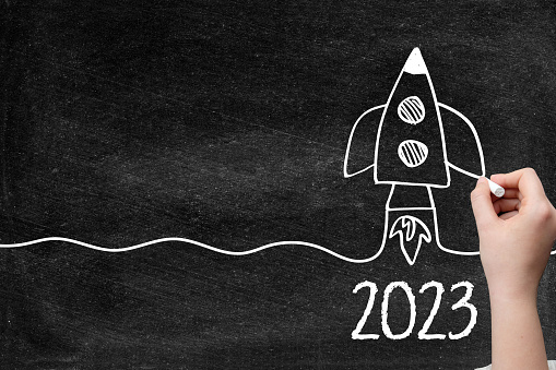 2023 Rocket drawing for creative idea concept, computer graphic with chalk drawings blackboard.