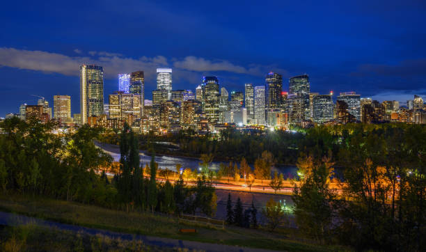 Skyline of Calgary with Bow River in Canada at night stock photo
