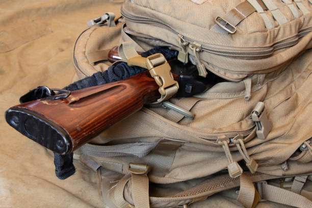 istock Military green backpack with a machine gun on a green background, backpack of a Ukrainian soldier, war in Ukraine 2022 1397183473