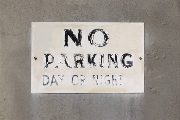 istock Faded No parking sign on an old concrete wall 1397186759