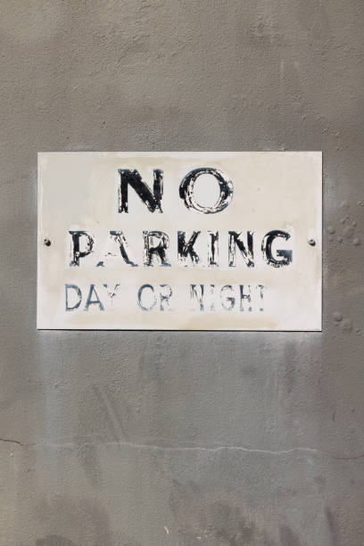 istock Faded No parking sign on an old concrete wall 1397186800