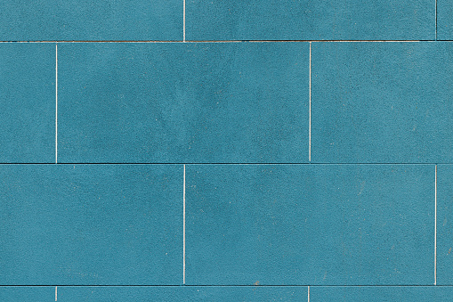 Close-up on a blue concrete wall.