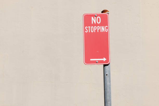istock Red No stopping sign on a metal pole 1397187632